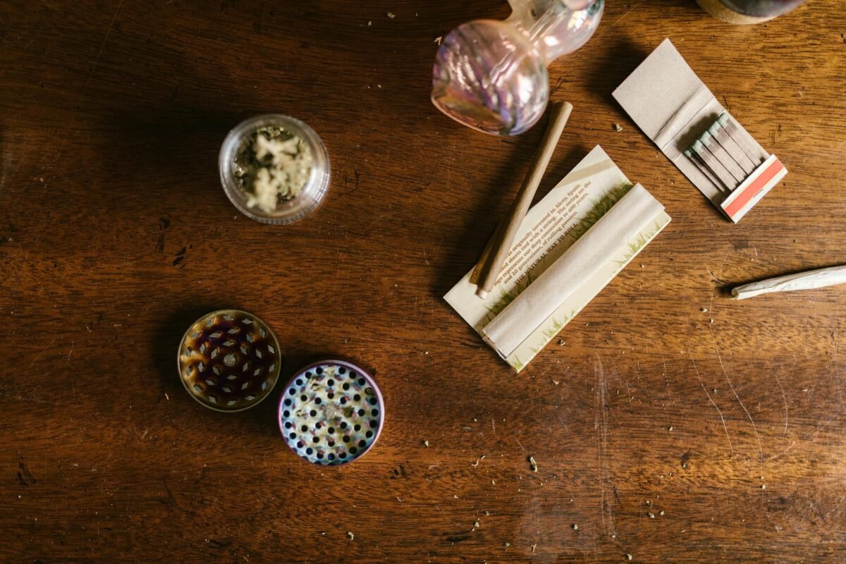 weed paraphernalias on top of wooden table